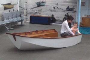 A child plays on part of a Mirror hull at the museum