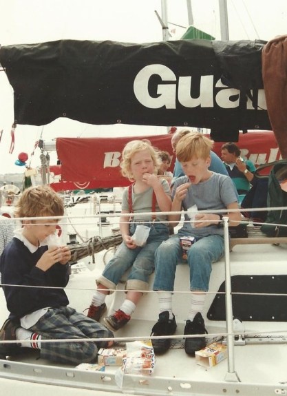 Fastnet welcome home party finds the boat's leftover crisps! l to r: Ben, Georgia and William. Photo Susannah Rodgers.
