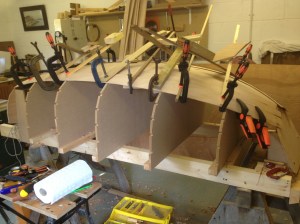 Planking under way, using clamps while the glue dries