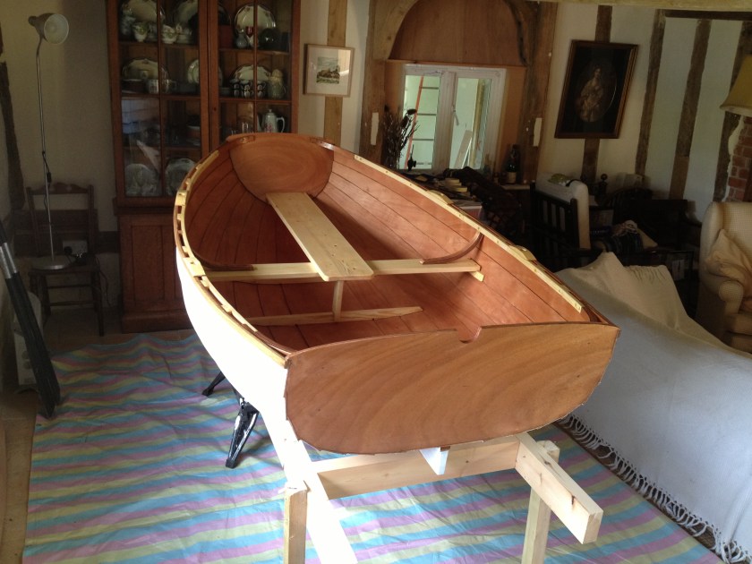 The finished boat, primed inside and out and moved from the workshop into the house for the final coats of paint and varnish