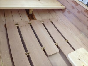 Bottom boards in place, held down by toggles screwed to the floors.